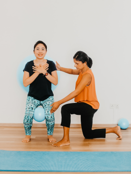 Physiotherapist guiding a patient through a lower limb rehabilitation exercise for heel pain at Embrace Physiotherapy, Singapore